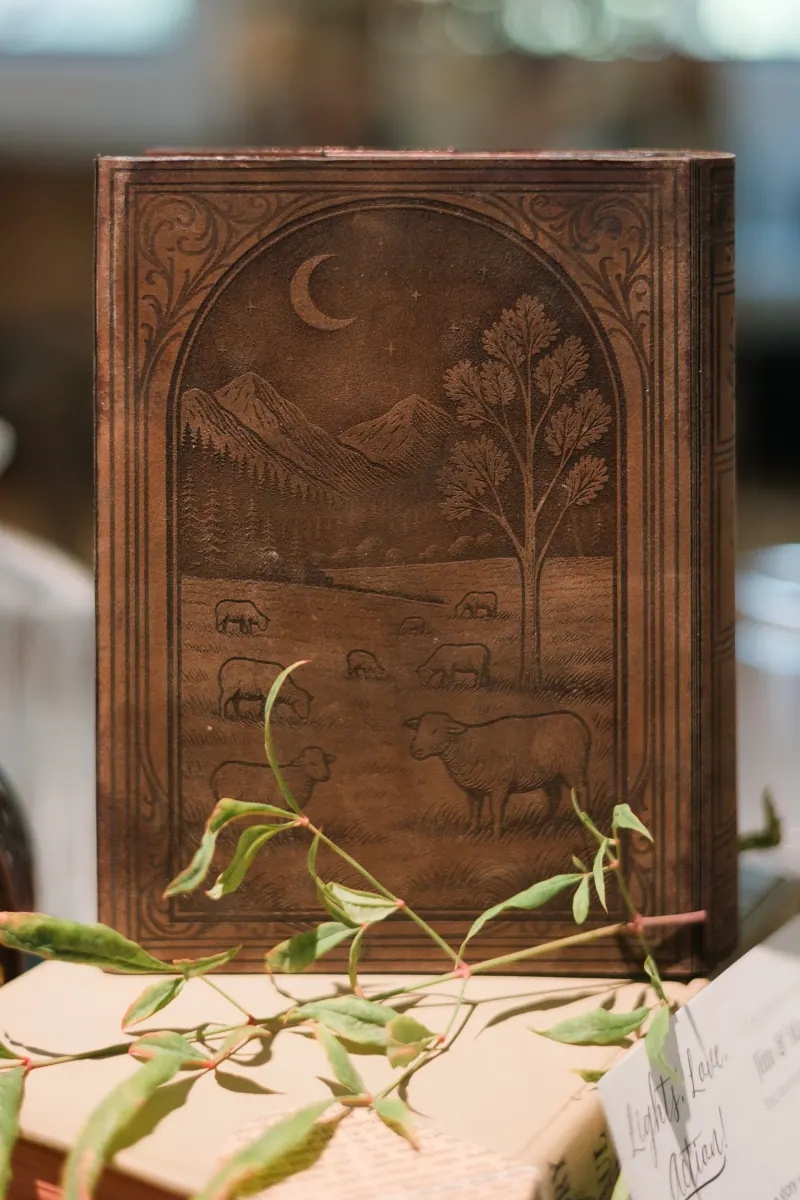 Book invitation staged with wedding details